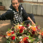 
              In this Oct. 12, 2019, photo provided by Angie Morton, Lisa Taylor poses with a flower arrangement taken at Rachel’s Flowers in Memphis, Tenn. An emergency management official in Shelby County, Tenn., said Taylor was found dead Saturday, Dec. 11, 2021, after a tree uprooted in a violent storm fell through the roof of her Memphis home, landing on Taylor as she slept. Co-workers said she recently left her job as a florist of 14 years for a government job at the Memphis airport. (Angie Morton via AP)
            
