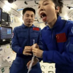 
              In this image taken from video footage run by China's CCTV, astronaut Wang Yaping, right, demonstrates how to consume water in zero gravity during a lesson for Chinese children through video link from the China's space station orbiting earth on Thursday, Dec. 9, 2021. (CCTV via AP)
            