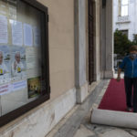 
              A woman unfolds a carpet outside the Catholic Cathedral Basilica of St. Dionysius the Areopagite, one day ahead of the visit of Pope Francis in Athens, Greece, Friday, Dec. 3, 2021. Francis is on a five-day trip to Cyprus and Greece by drawing attention once again to his call for Europe to welcome migrants. (AP Photo/Yorgos Karahalis)
            