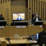 
              Presiding judge Hendrik Steenhuis, left, during the ongoing trial and criminal proceedings regarding the downing of Malaysia Airlines flight MH17, at the high security court at Schiphol airport, near Amsterdam, Netherlands, Monday Dec. 20, 2021. Prosecutors are scheduled to begin explaining evidence and their case to judges Monday in the murder trial of three Russians and a Ukrainian charged with involvement in downing Malaysia Airlines flight MH17 over eastern Ukraine in 2014, killing all 298 passengers and crew. (AP Photo/Peter Dejong)
            
