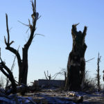 
              Andrew Ellison, left, and Melissa Collins look over the remains of a rental property they own Sunday, Dec. 12, 2021, in Mayfield, Ky. Tornadoes and severe weather caused catastrophic damage across several states Friday, killing multiple people overnight. (AP Photo/Mark Humphrey)
            