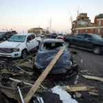 
              Damaged cars sit across the street from the damaged Graves County Courthouse Sunday, Dec. 12, 2021, in Mayfield, Ky. Tornadoes and severe weather caused catastrophic damage across several states Friday, killing multiple people. (AP Photo/Mark Humphrey)
            