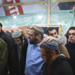 
              Mourners attend the funeral of Yehuda Dimentman, 25, who was killed in a shooting attack by a Palestinian gunman near the Jewish outpost of Homesh in the West Bank, Friday, Dec. 17, 2021. At least one Palestinian gunman opened fire Thursday night at a car filled with Jewish seminary students next to a West Bank settlement outpost, killing an Israeli man and lightly wounding two other people, Israeli officials said. (AP Photo/Moti Milrod)
            