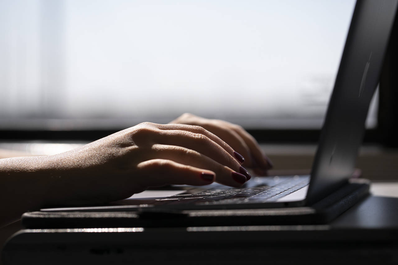 FILE - A woman types on a laptop on a train in New Jersey on May 18, 2021.  When you're trying to s...