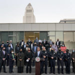 
              Joined by business owners and community leaders, Los Angeles Mayor Eric Garcetti, center, speaks during a news conference outside the Los Angeles Police Headquarters as City Hall is visible in the background in Los Angeles Thursday, Dec. 2, 2021. Authorities in Los Angeles on Thursday announced arrests in recent smash-and-grab thefts at stores, part of a rash of organized retail crime in California. (AP Photo/Jae C. Hong)
            