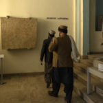 
              Visitors walk in front of a second century AC limestone in Bactrian Language on a Greek script in the National Museum of Afghanistan, in Kabul, Monday, Dec. 6, 2021. The National Museum of Afghanistan is open once again -- and the Taliban, whose members once smashed their way through the facility, destroying irreplaceable pieces of Afghanistan's national heritage, now appear to be among its most enthusiastic visitors. (AP Photo/Petros Giannakouris)
            