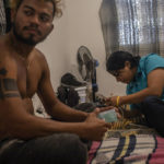 
              Honduran migrants Joseph Mateo, left, and Ricky, spend the day at a home in Monterrey, Nuevo Leon state, Mexico, Nov. 27, 2021, after obtaining one-year humanitarian visas allowing them to move about Mexico and work. (AP Photo/Felix Marquez)
            