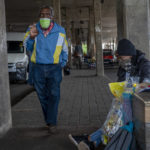 
              A woman selling snacks, sits at the Baragwanath taxi rank in Soweto, South Africa, Thursday Dec. 2, 2021. South Africa launched an accelerated vaccination campaign to combat a dramatic rise in confirmed cases of COVID-19 a week after the omicron variant was detected in the country. (AP Photo/Jerome Delay)
            