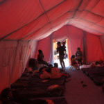 
              Migrants rest in a tent at a government camp after crossing into Chile from Bolivia, Chile, Friday, Dec. 10, 2021. (AP Photo/Matias Delacroix)
            