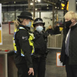 
              Britain's Prime Minister Boris Johnson meets British Transport Police officers at Liverpool Lime Street station, Liverpool, England, Monday Dec, 6, 2021, ahead of the publication of the government's 10-year drug strategy. (Christopher Furlong/Pool via AP)
            