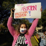 
              An abortion rights supporter holds one of many signs that was displayed at a reproductive rights rally at Smith Park in Jackson, Miss., Wednesday, Dec. 1, 2021. The U.S. Supreme Court on Wednesday heard a Mississippi case that directly challenges the constitutional right to an abortion established nearly 50 years ago. (AP Photo/Rogelio V. Solis)
            