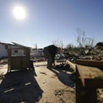 
              Martha Thomas salvages possessions from her destroyed home in the aftermath of tornadoes that tore through the region, in Mayfield, Ky., Monday, Dec. 13, 2021. (AP Photo/Gerald Herbert)
            