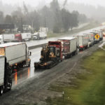 
              Dozens of semi-trucks sit parked along northbound Interstate 5 at Mountain Gate about 10 miles north of Redding, Calif., on Wednesday, Dec. 15, 2021. Heavy snow, blizzard conditions and stuck vehicles have prompted authorities to impose a shutdown of a portion of the West Coast's major interstate that links California with Oregon. California officials Wednesday afternoon closed Interstate 5 north of the city of Redding as the latest of back-to-back storms slammed the region. (Mike Chapman/The Record Searchlight via AP)
            