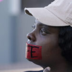 
              Abortion opponent Alisha Parnell of Gulfport, cries as she offers silent prayer while wearing a tape across her mouth with the word "Life" written across it, while standing outside the Jackson Women's Health Organization, a state-licensed abortion clinic in Jackson, Miss., Wednesday, Dec. 1, 2021. A group of anti-abortion activists stood outside the clinic in an effort to dissuade patients from entering. On Wednesday, the U.S. Supreme Court heard a case that directly challenges the constitutional right to an abortion established nearly 50 years ago. (AP Photo/Rogelio V. Solis)
            