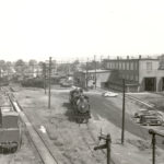 The old Northern Pacific Roundhouse in Auburn, where Frank Cavanaugh's engineer shift would end, and where he would wait for a ride home from his wife. From the formal caption of the photo, taken May 25, 1946: "View looking north. NPRy Machine shop and roundhouse at left, diesel shop at right. Tank contains diesel oil. Cinder cars in gondola cars contain ashes and cinders from spent locomotive fires. Roundhouse office is close to far left lower corner, in front of machine shop which was attached to roundhouse." (Courtesy White River Valley Museum)