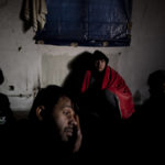 
              Migrants gather near the Hungarian border, outside of the village of Martonosh, Serbia, Thursday, Jan. 13, 2022. Hungary's nationalist prime minister, Viktor Orban, is keen to use the threat of migrants at his country's southern border to give him an advantage in upcoming elections. But the scale of migration pressure claimed by Orban is drawn into question by statistics from neighboring Serbia and the European Union's border agency.  (AP Photo/Bela Szandelszky)
            