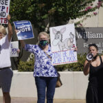 
              FILE - Protesters gather outside where Texas Governor Greg Abbott signed into law legislation that further tightens Texas' strict voting laws on Sept. 7, 2021 in Tyler, Texas. A sweeping new Texas voting law that Republicans muscled through the Legislature last year over dramatic protests is drawing fire again, even before some of the most contentious restrictions and changes kick in ahead of the state's first-in-the nation primary. AP Photo/LM Otero, File)
            