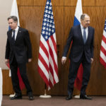 
              US Secretary of State Antony Blinken, left, and Russian Foreign Minister Sergey Lavrov move to their seats before their meeting, Friday, Jan. 21, 2022, in Geneva, Switzerland. (AP Photo/Alex Brandon, Pool)
            
