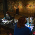 
              Two women get a manicure at the Van Gogh museum in Amsterdam, Wednesday, Jan. 19, 2022, as Dutch museums, theaters and concert halls played host Wednesday to businesses that are allowed to open to customers as a protest against their own continuing lockdown closures. (AP Photo/Peter Dejong)
            