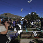 
              Renee Maldonado, a niece of murdered journalist Lourdes Maldonado, shouts "fly free auntie," as doves are released during her burial service at the Monte de los Olivos cemetery in Tijuana, Mexico, Thursday, Jan. 27, 2022. Maldonado, who was shot dead in her car when arriving home on Sunday, Jan. 23, was the third journalist killed in Mexico this year and the second in a space of two weeks in the border town of Tijuana. (AP Photo/Marco Ugarte)
            
