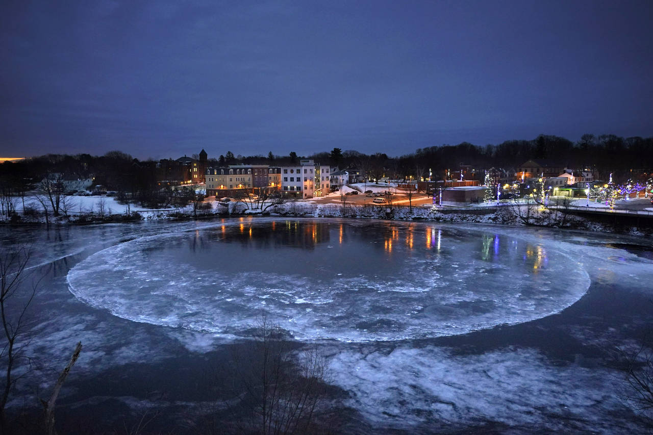 A large ice disk slowly rotates in the Presumpscot River in Westbrook, Maine, Thursday, Jan. 13, 20...