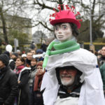 
              A protestor wears a costume as he marches during a demonstration against COVID-19 measures in Brussels, Sunday, Jan. 23, 2022. Demonstrators gathered in the Belgian capital to protest what they regard as overly extreme measures by the government to fight the COVID-19 pandemic, including a vaccine pass regulating access to certain places and activities and possible compulsory vaccines.(AP Photo/Geert Vanden Wijngaert)
            