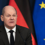 
              German Chancellor Olaf Scholz sits in front of a camera as he delivers his speech for the Davos Agenda 2022, at the chancellery in Berlin, Germany, Wednesday, Jan. 19, 2022. The Davos Agenda, which takes place from Jan. 17 to Jan. 21, 2022, is an online edition of the annual Davos meeting of the World Economy Forum due to the coronavirus pandemic. (AP Photo/Markus Schreiber, Pool)
            