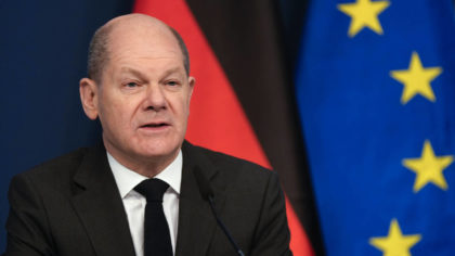 German Chancellor Olaf Scholz sits in front of a camera as he delivers his speech for the Davos Age...