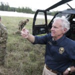 
              FILE - South Carolina Gov. Henry McMaster talks about rising floodwaters after Florence struck the Carolinas, Monday, Sept. 17, 2018, near Wallace, S.C. Facing state budgets that are flush with cash, Democratic and Republican governors alike want to spend part of their windfalls on projects aimed at slowing climate change and guarding against its consequences, from floods and fires to cleaning up dirty air. (AP Photo/Sean Rayford, File)
            