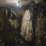 
              Ukrainian servicemen put on protective equipment before moving to front line position in the Luhansk area, eastern Ukraine, Thursday, Jan. 27, 2022. The U.S. rejection of Russia's main demands to resolve the crisis over Ukraine left "little ground for optimism," the Kremlin said Thursday, but added that dialogue was still possible. (AP Photo/Vadim Ghirda)
            