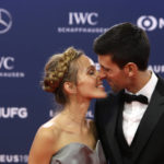 
              FILE - Serbian tennis player Novak Djokovic and his wife Jelena kiss as they arrive for the 2019 Laureus World Sports Awards, Feb. 18, 2019. The 34-year-old Serb and his wife, Jelena, share new age, esoteric beliefs and together have visited the Bosnian hill town of Visoko, where some believe that four hills shaped like pyramids offer healing powers, a claim disputed by scientists. (AP Photo/Claude Paris, File)
            