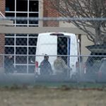 
              Law enforcement officials gather at Colleyville Elementary School near the Congregation Beth Israel synagogue on Saturday, Jan. 15, 2022 in Colleyville, Texas. Authorities said a man took hostages Saturday during services at the synagogue where the suspect could be heard ranting in a livestream and demanding the release of a Pakistani neuroscientist who was convicted of trying to kill U.S. Army officers in Afghanistan. (AP Photo/Tony Gutierrez)
            