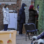 
              Residents wearing face masks to help protect from the coronavirus line up to get a throat swab at a COVID-19 test site outside a residential housing block in Fengtai District in Beijing, Wednesday, Jan. 26, 2022. The Chinese capital reported an uptick more than dozen daily new COVID-19 cases as it began a third round of mass testing of millions of people Wednesday in the run-up to the Winter Olympics. (AP Photo/Andy Wong)
            