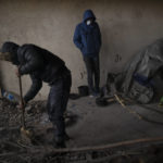 
              Migrants clean an abandoned hangar while bracing against harsh winter weather near the Hungarian border, outside of the village of Majdan, Serbia, Tuesday, Jan. 11, 2022. Hungary's nationalist prime minister, Viktor Orban, is keen to use the threat of migrants at his country's southern border to give him an advantage in upcoming elections. But the scale of migration pressure claimed by Orban is drawn into question by statistics from neighboring Serbia and the European Union's border agency.  (AP Photo/Bela Szandelszky)
            