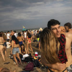 
              Teenagers dance late afternoon at the beach in Pinamar, Buenos Aires province, Argentina, Saturday, Jan. 15, 2022. Amid a rebound in infections by the new Omicron variant of COVID 19, thousands of vacationers in Argentina fill the beaches in one of the hottest summers in recent years. (AP Photo/Rodrigo Abd)
            