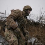 
              A Ukrainian serviceman ducks in a trench on the front line in the Luhansk region, eastern Ukraine, Friday, Jan. 28, 2022. High-stakes diplomacy continued on Friday in a bid to avert a war in Eastern Europe. The urgent efforts come as 100,000 Russian troops are massed near Ukraine's border and the Biden administration worries that Russian President Vladimir Putin will mount some sort of invasion within weeks. (AP Photo/Vadim Ghirda)
            