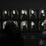 
              Visitors watch the Italian photographer Giovanni Gastel's photo exhibition 'The people I like',at the Triennale museum, in Milan, Italy, Friday, Jan. 14, 2022. The exhibition will be on until March 13, 2022.(AP Photo/Luca Bruno)
            