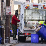 
              Municipal sanitation workers collect trash in Philadelphia, Thursday, Jan. 13, 2022. The omicron variant is sickening so many sanitation workers around the U.S. that waste collection in Philadelphia and other cities has been delayed or suspended. (AP Photo/Matt Rourke)
            