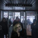 
              A woman speaks on the phone as she entering the subway in Kharkiv, Ukraine, Friday, Jan. 28, 2022. The situation in Kharkiv, just 40 kilometers (25 miles) from some of the tens of thousands of Russian troops massed at the border of Ukraine, feels particularly perilous. Some people in Ukraine's second-largest city are preparing to fight back if Russia invades. (AP Photo/Evgeniy Maloletka)
            