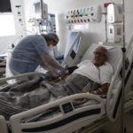 
              A nurse treats COVID-19 patient João Claudio Ribeiro, 70, at the Dr. Ernesto Che Guevara hospital in Marica, Brazil, Wednesday, Jan. 26, 2022. (AP Photo/Bruna Prado)
            