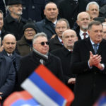 
              Bosnian Serb political leader Milorad Dodik, front right, applauds during a parade marking the 30th anniversary of the Republic of Srpska in Banja Luka, northern Bosnia, Sunday, Jan. 9, 2022. Dodik was slapped with new U.S. sanctions for alleged corruption. Dodik maintains the West is punishing him for championing the rights of ethnic Serbs in Bosnia — a dysfunctional country of 3.3 million that's never truly recovered from a fratricidal war in the 1990s that became a byname for ethnic cleansing and genocide. (AP Photo/Radivoje Pavicic)
            