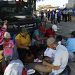 
              Migrants who are part of a caravan hoping to reach the United States, rest in Corinto, Honduras, Saturday, Jan. 15, 2022. (AP Photo/Delmer Martinez)
            