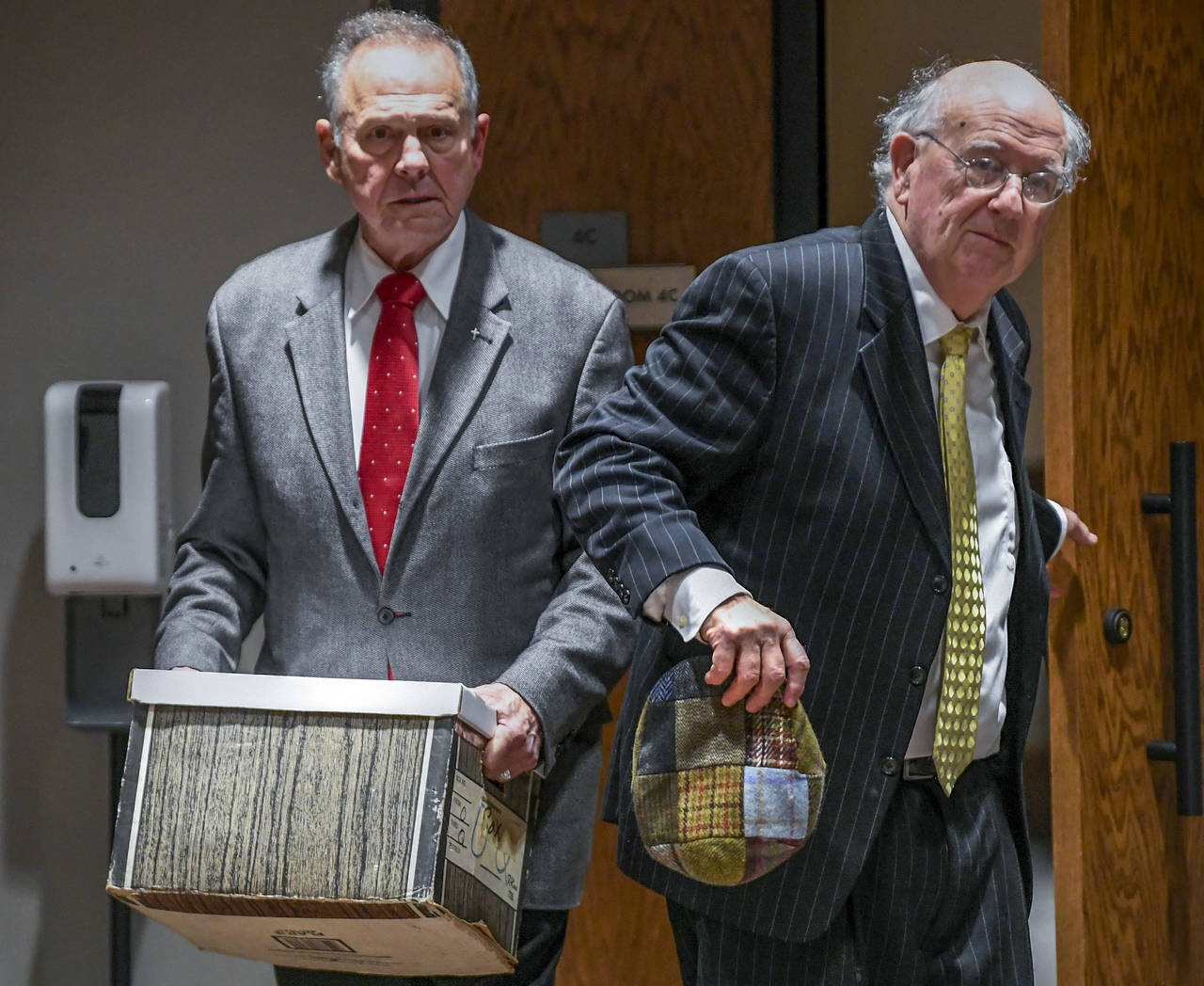 Former Alabama Chief Justice Roy Moore, left, and his attorney Julian McPhillips leave the courtroo...