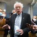 
              FILE - Sen. Bernie Sanders, I-Vt., makes comments to reporters about Sen. Joe Manchin, D-W.Va., as he walks to the Senate Chamber for a vote, on Dec. 15, 2021, in Washington. Just over a year ago, millions of energized young people, women, voters of color and independents joined forces to send Joe Biden to the White House. But 12 months after he entered the Oval Office, many describe a coalition in crisis.(AP Photo/Jacquelyn Martin, File)
            