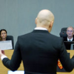 
              FILE - Co-judge Henriette Thoner, left, and judge Dag Bjoervik listen to convicted mass murderer Anders Behring Breivik, back to camera, on the first day of a hearing where he is seeking parole, in Skien, Norway, Jan. 18, 2022. A decade after the 2011 bombing and shooting spree that left 77 dead, Breivik is seeking early release from a 21-year sentence — the maximum term in Norway. (Ole Berg-Rusten/NTB scanpix via AP, File)
            
