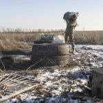 
              In this photo taken Thursday, Jan. 20, 2022, a Ukrainian soldier carries a package at the line of separation from pro-Russian rebels, Mariupol, Donetsk region, Ukraine. U.S. President Joe Biden said Thursday that any Russian troop movements across Ukraine’s border would constitute an invasion and that Moscow would “pay a heavy price” for such an action. (AP Photo/Andriy Dubchak)
            