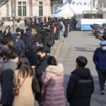 
              People queue in line for the coronavirus test at a temporary screening clinic for the coronavirus in Seoul, South Korea, Thursday, Jan. 27, 2022. (AP Photo/Lee Jin-man)
            