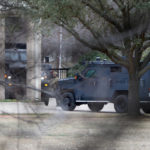 
              CORRECTS BYLINE TO ELIAS VALVERDE INSTEAD OF LYNDA M. GONZALEZ - Law enforcement teams stage near Congregation Beth Israel while conducting SWAT operations in Colleyville, Texas on Saturday afternoon, Jan. 15, 2022. Authorities said a man took hostages Saturday during services at the synagogue where the suspect could be heard ranting in a livestream and demanding the release of a Pakistani neuroscientist who was convicted of trying to kill U.S. Army officers in Afghanistan. (Elias Valverde/The Dallas Morning News via AP)
            