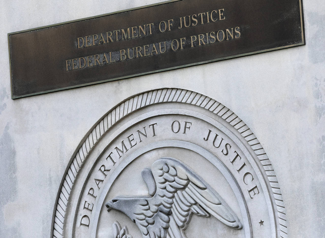 FILE - In this July 6, 2020, photo, a sign for the Department of Justice Federal Bureau of Prisons ...