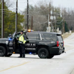 
              Law enforcement officials block Pleasant Run Road near Congregation Beth Israel synagogue where a man took hostages during services on Saturday, Jan. 15, 2022, in Colleyville, Texas. (AP Photo/Tony Gutierrez)
            